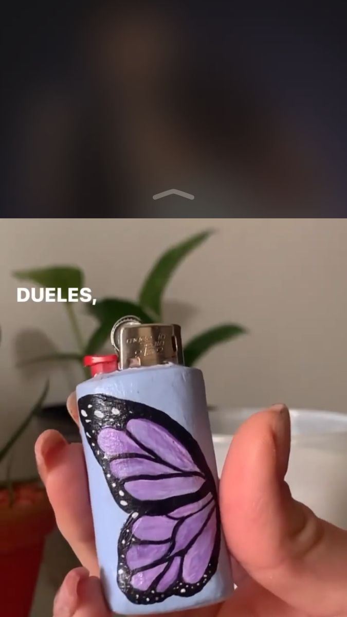 a person holding a lighter with a butterfly on it's side and the caption reads, duples