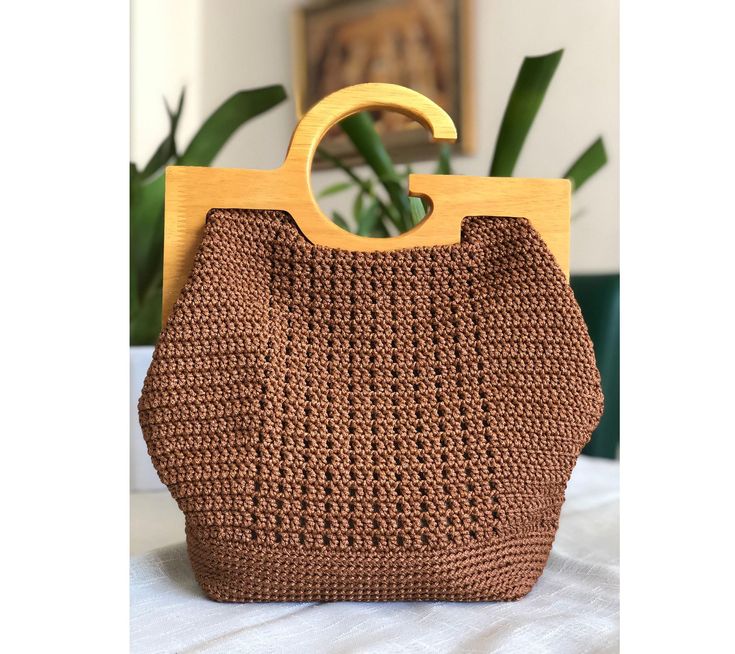 -Size : 25x25x12cm -This bag, which will be the choice of women who feel young, is made with completely natural materials. -A small gift is waiting for you Trendy Brown Crochet Bag With Leather Handles, Handmade Brown Crochet Bag With Top Handle, Everyday Crochet Tote Bag With Bamboo Handle, Everyday Brown Crochet Bag With Top Handle, Trendy Natural Crochet Top Handle Bag, Everyday Brown Crochet Top Handle Bag, Handmade Brown Straw Bag For Everyday Use, Brown Crochet Bag With Round Handle For Daily Use, Brown Square Crochet Bag For Shopping