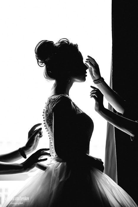 a woman in a ball gown getting her hair done