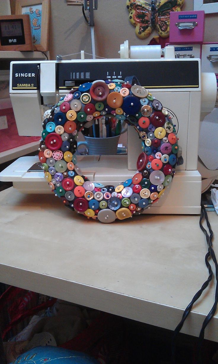 a sewing machine sitting on top of a table with buttons all over the front of it