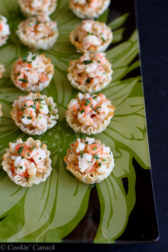 small appetizers are arranged on a green plate