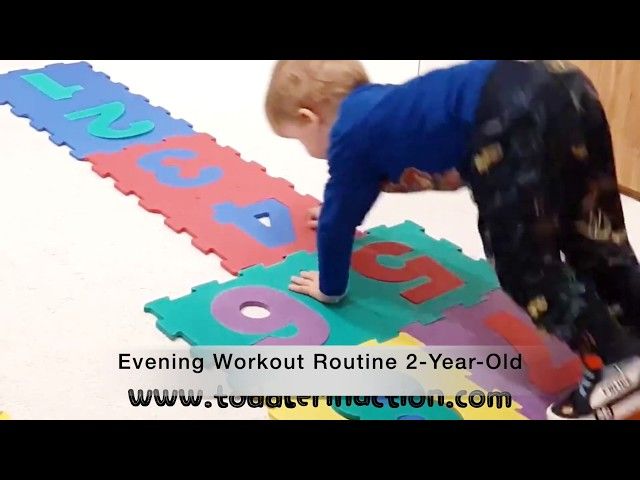 a young boy is playing with foam letters on the floor