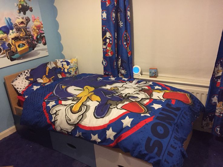 a bed with sonic the hedgehog bedspread and matching comforter in a child's bedroom