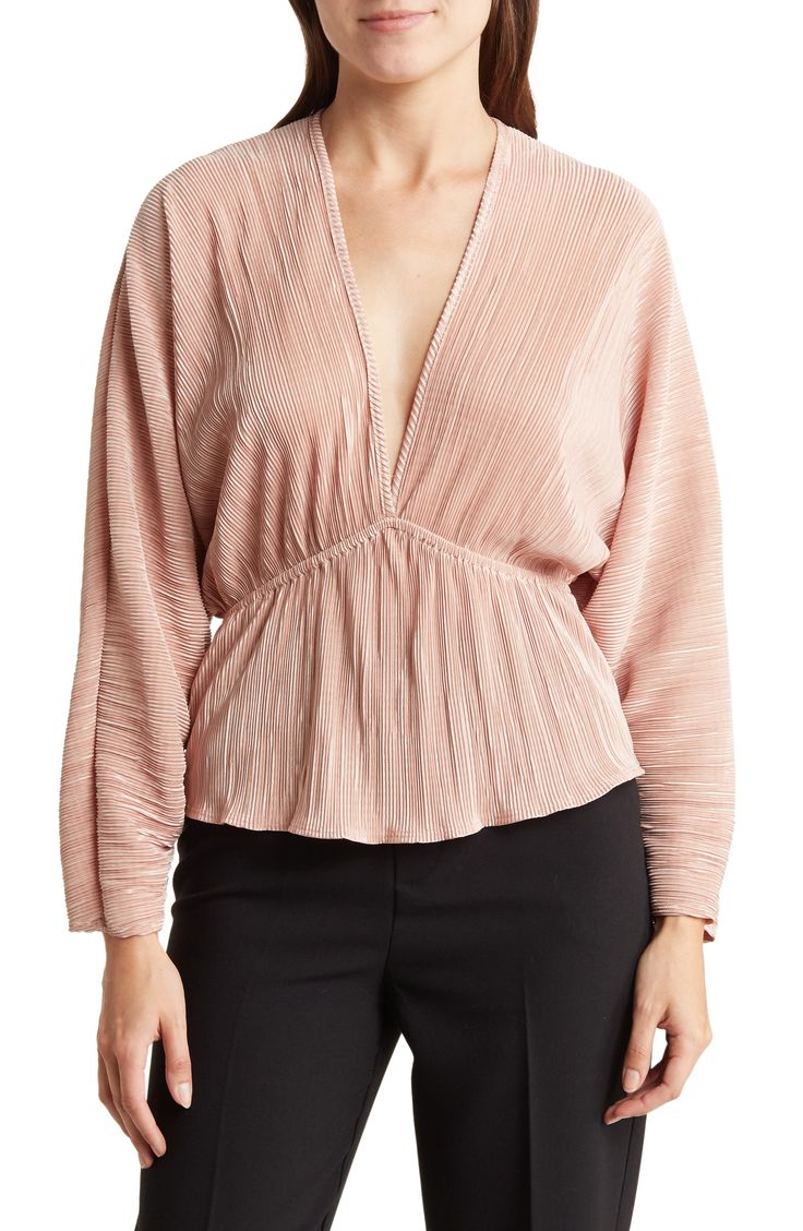 Plisse pleats texture a lightweight top fashioned with long dolman sleeves and a fluttery peplum. 23" length Deep V-neck Long sleeves 100% polyester Machine wash, line dry Made in the USA Model stats: 5'10" height, 32" bust, 25" waist, 36" hip. Model is wearing size Small. Spring Pleated V-neck Blouse, Spring Chic V-neck Peplum Top, Pleated V-neck Blouse For Spring, Chic Spring Peplum Top For Brunch, Spring Billowy Ruched Blouse, Spring Ruched Tops For Date Night, Elegant Blouse With Folds For Spring, Ruched Tops For Date Night In Spring, Billowy Long Sleeve Ruched Top