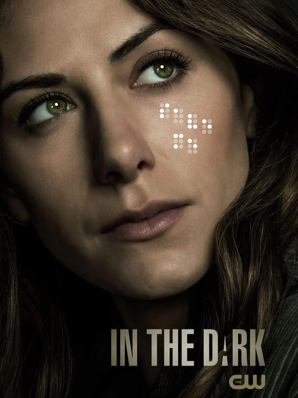 a woman with cross marks on her face and the words in the dark above her