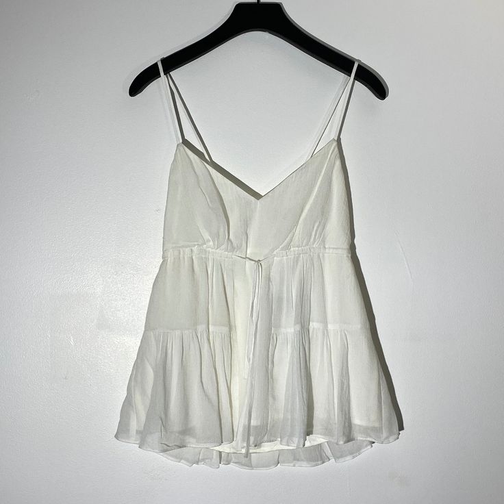 Double Layer Flowy Chiffon Babydoll Top Size Small Front Tie Detail (Cinches At Top, Refer To Image) New With Tags Flowy Mini Length Tops For Beach, Summer Chiffon Top For Daywear, White Chiffon Top For Brunch, White Ruffled Camisole For Beach, Chic Peplum Top For Summer Daywear, Chic Mini Length Camisole For Spring, Chic Summer Peplum Top For Daywear, Spring Chic Mini Length Camisole, Chic Spring Mini Length Camisole