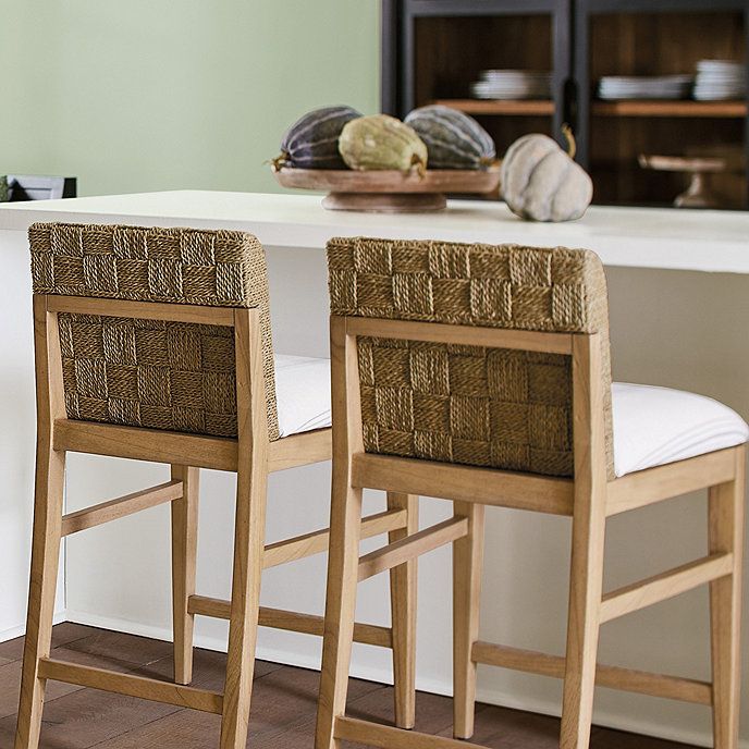 two chairs sitting next to each other in front of a counter