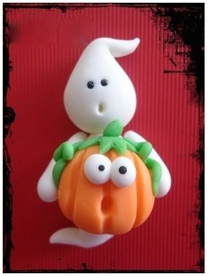 a plastic figurine holding a pumpkin with goo eyes on it's back