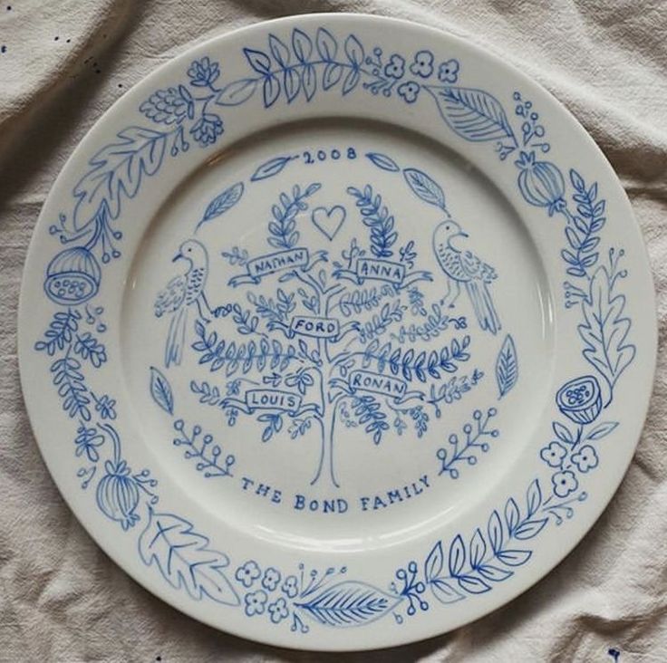 a blue and white plate sitting on top of a cloth covered table next to a paper towel