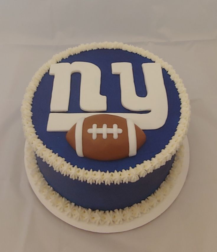 a new york giants football themed cake on a white tablecloth covered table with cloths