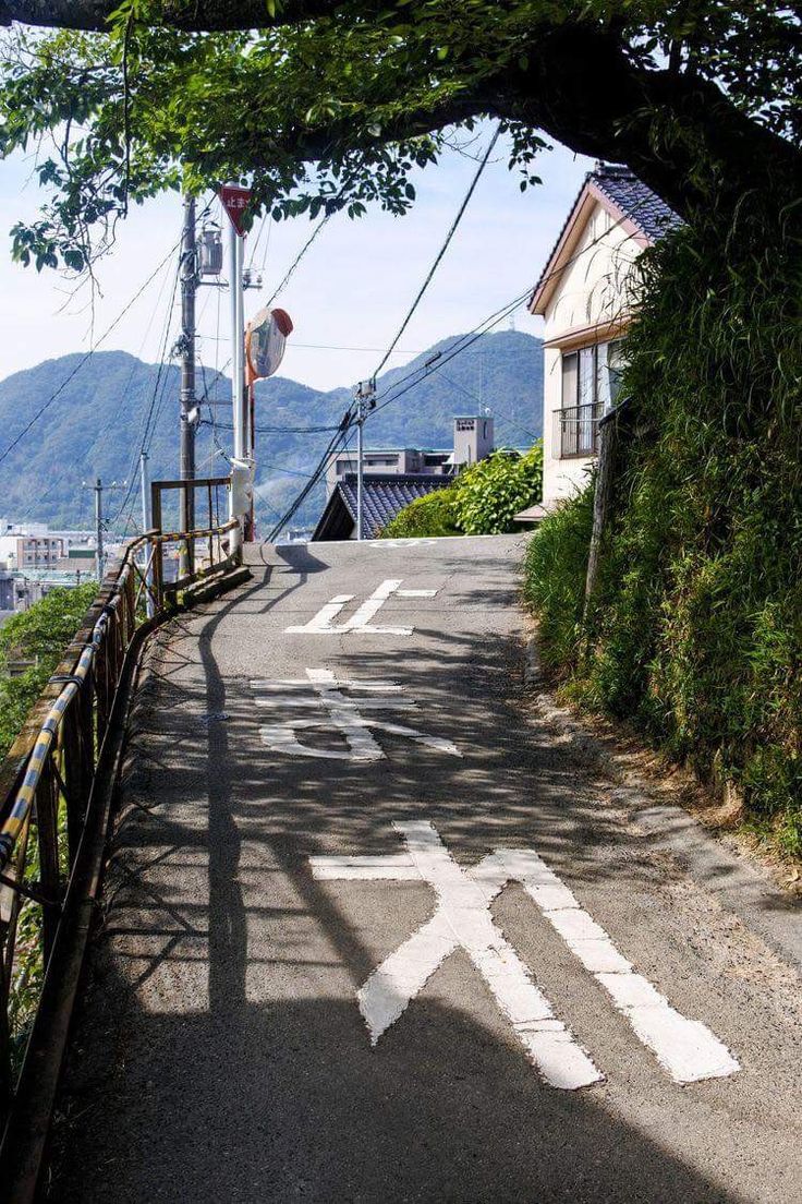 an arrow painted on the side of a road