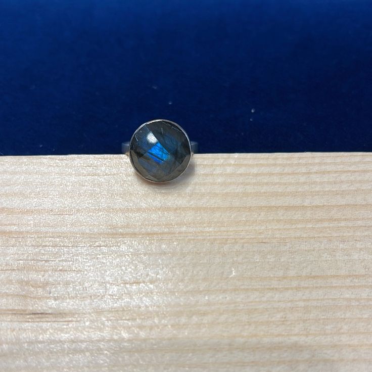 a blue stone sitting on top of a wooden board