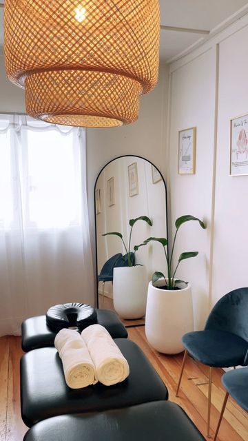 a living room filled with furniture and a mirror