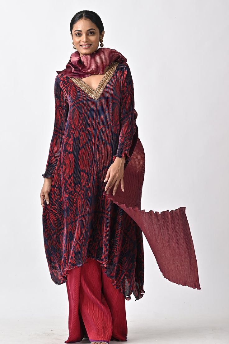 Maroon kaftan with abstract print, pleats and hand embroidery.
Components: 1
Pattern: Printed, Hand Embroidered
Type Of Work: Abstract
Neckline: V Neck
Sleeve Type: Full
Fabric: Pleated polyester mix
Color: Maroon
Other Details: 
Note : Pant and dupatta worn by the model are not for sale.
Occasion: Mehendi and Haldi,Sangeet - Aza Fashions Anarkali Long Sleeve Kaftan With Printed Motifs, Anarkali Style Long Sleeve Printed Kaftan, Anarkali Ikat Print Kurta For Eid, Evening Kurta With Dupatta In Traditional Drape, Traditional Evening Kurta With Dupatta, Festive Ikat Print Tunic Dress, Festive Silk Kurta With Ikat Print, Silk Anarkali Kaftan With Long Sleeves, Silk Anarkali Long Sleeve Kaftan