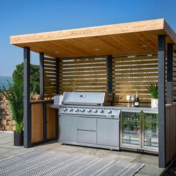 an outdoor bbq with grill and seating area