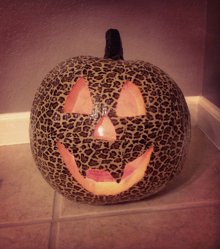 a leopard print pumpkin sitting on the floor