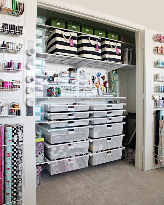 an organized closet with lots of crafting supplies and storage bins on the shelves