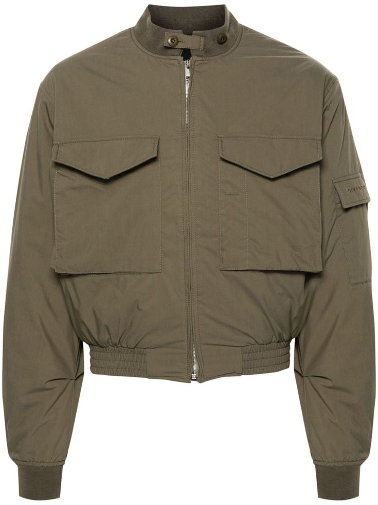 olive green cotton blend padded design ribbed band collar button-fastening straps two chest flap pockets long sleeves sleeve flap pocket embroidered logo at the sleeve cropped ribbed cuffs and hem gusset detail to the rear internal slip pocket full lining branded zip puller front zip fastening Utility Style Cropped Jacket With Flap Pockets, Casual Cropped Winter Jacket With Patch Pockets, Casual Cropped Jacket With Patch Pockets For Winter, Utility Cropped Jacket With Pockets For Winter, Spring Cropped Jacket With Ribbed Cuffs, Winter Cropped Utility Jacket With Pockets, Urban Cropped Outerwear With Pockets, Cropped Winter Utility Jacket With Pockets, Cropped Utility Outerwear For Winter