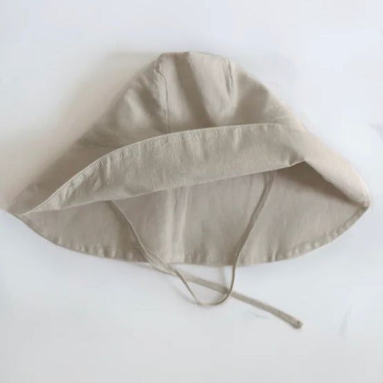 Nothing embodies summer quite like a wide-brimmed, floppy hat. But, this is no ordinary sun hat! Mindfully made from the softest organic linen and designed with a soft structured brim, it’s simply the most stylish way to shade your eyes (it even has a handy chin tie for breezy beach days). GOTS certified and free from harmful chemicals, our organic linen is luxuriously airy. It’s sourced from rare organic flax from the mountains of France to retain its durable, rustic appearance yet incredibly s Beige Cotton Sun Hat For Everyday, Everyday Beige Cotton Sun Hat, Cream Brimmed Cotton Sun Hat, Beige Cotton Wide Brim Sun Hat, Beige Wide Brim Cotton Sun Hat, Casual Linen Brimmed Bucket Hat, Beige Cotton Sun Hat With Curved Brim, Summer Sun Hat In Solid Color For Everyday, Summer Brimmed Hats In Neutral Color