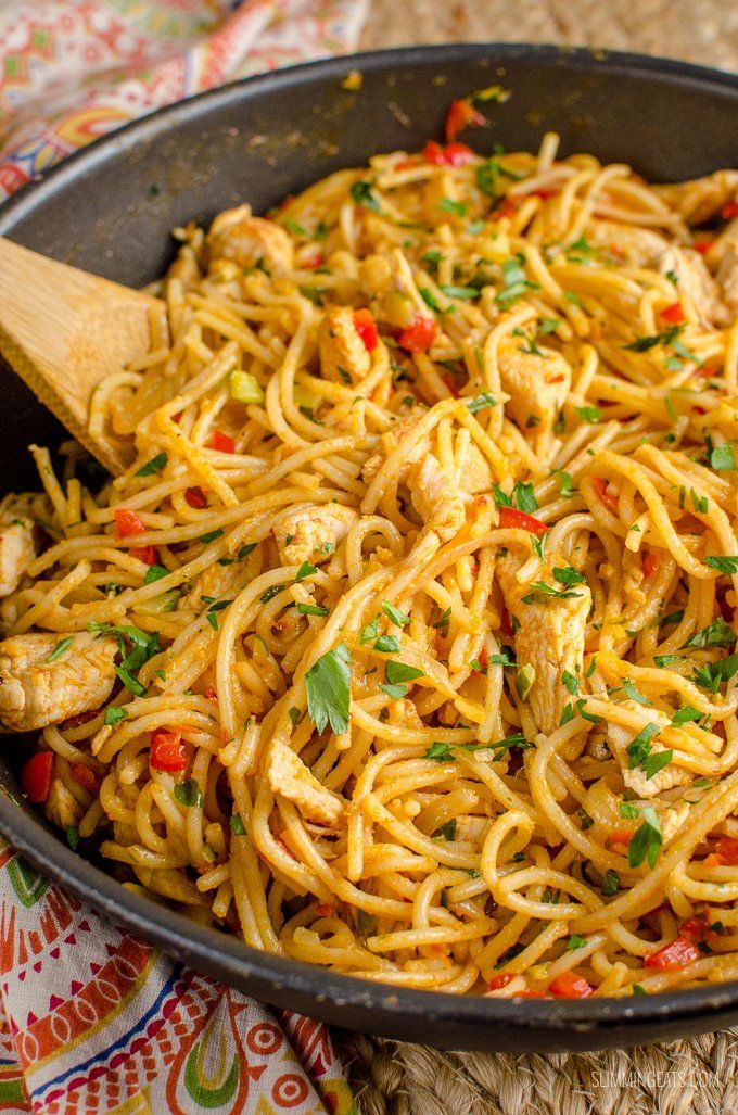 a skillet filled with pasta and chicken