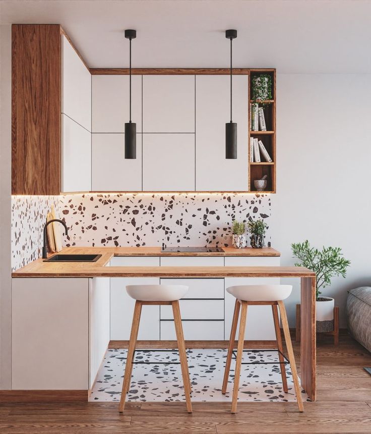 a kitchen with two stools next to a table and bookshelf on the wall