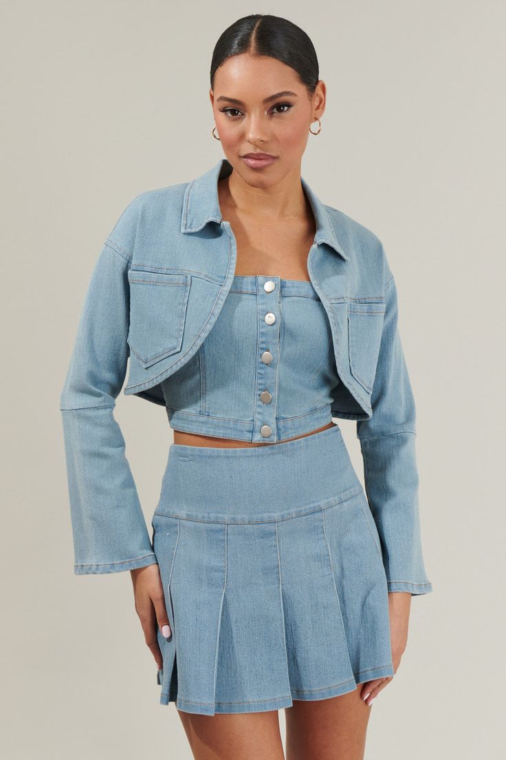 Denim Up with the adorable Roslyn Denim Bolero Cropped Jacket! Long bell sleeves adorn this cropped jacket. It has a collared neck with pockets on each side. Wear it with its matching denim top and skirt to complete your outfit! - Cropped- Denim- Bolero- Pockets- Color: Lt-denimSize + Fit - Model is 5'8" and wearing size XS- Measurements taken from size S - Chest: 8 3/4"- Length: 16" Fabric Self:75% Cotton 22% Polyester 3% Spandex Style Number STJ8115DR Chic Cropped Denim Vest In Medium Wash, Chic Cropped Medium Wash Denim Vest, Spring Cropped Denim Top With Button Closure, Blue Cropped Jacket With Button Closure, Trendy Cropped Denim Vest With Button Closure, Cropped Summer Jacket With Pockets, Summer Cropped Jacket With Pockets, Cropped Jacket With Pockets For Summer, Denim Blue Cotton Cropped Jacket