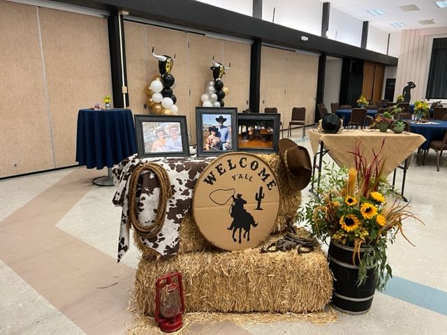 there is a hay bale that has been decorated with cow print and cowboy decorations