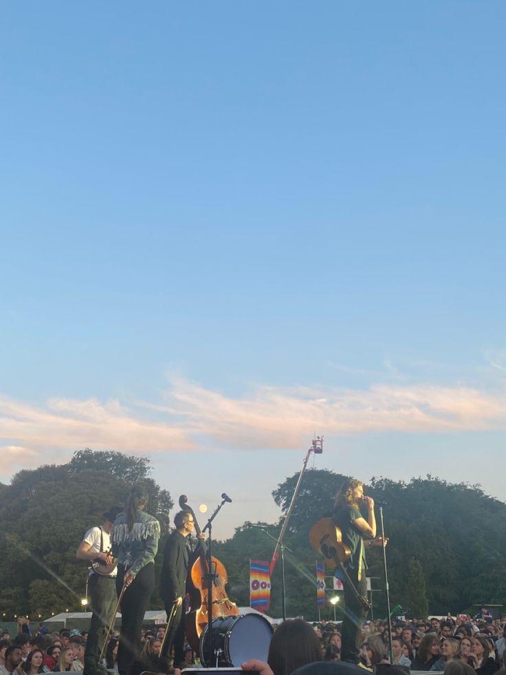 a group of people standing on top of a stage next to each other in front of a crowd