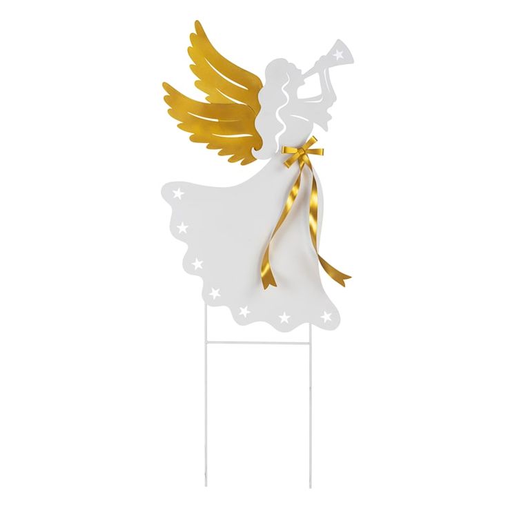 a white and gold angel standing on top of a wooden stand with stars around it