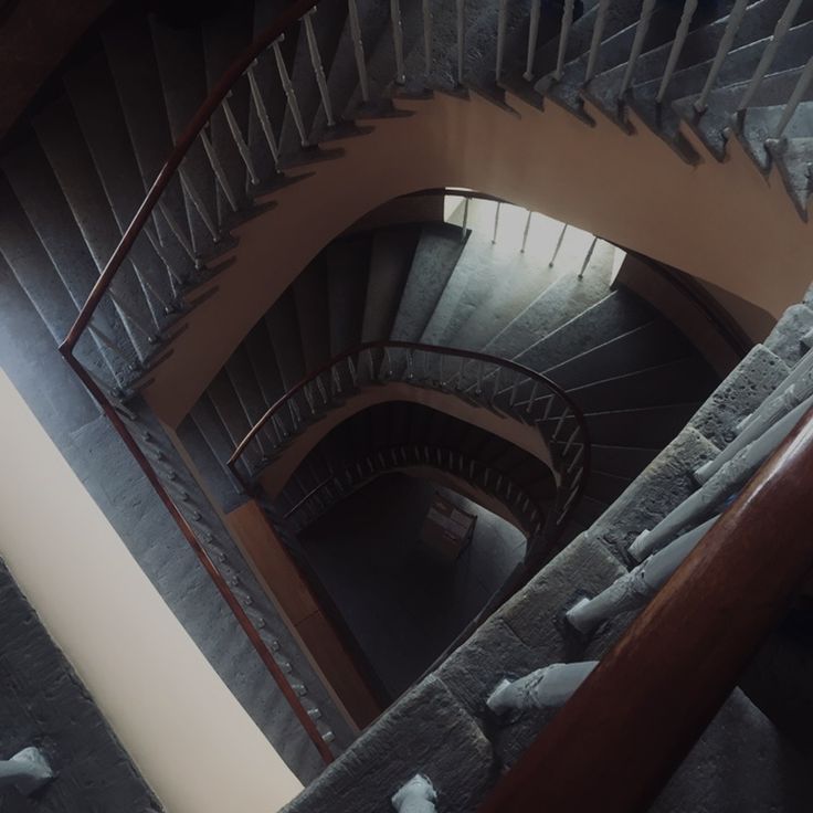 a spiral staircase in an old building with snow on the ground