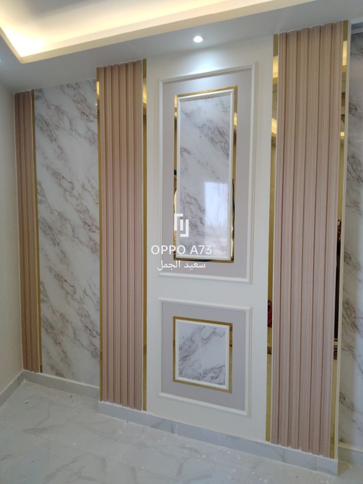 an empty room with marble walls and gold trim around the windows, along with vertical blinds