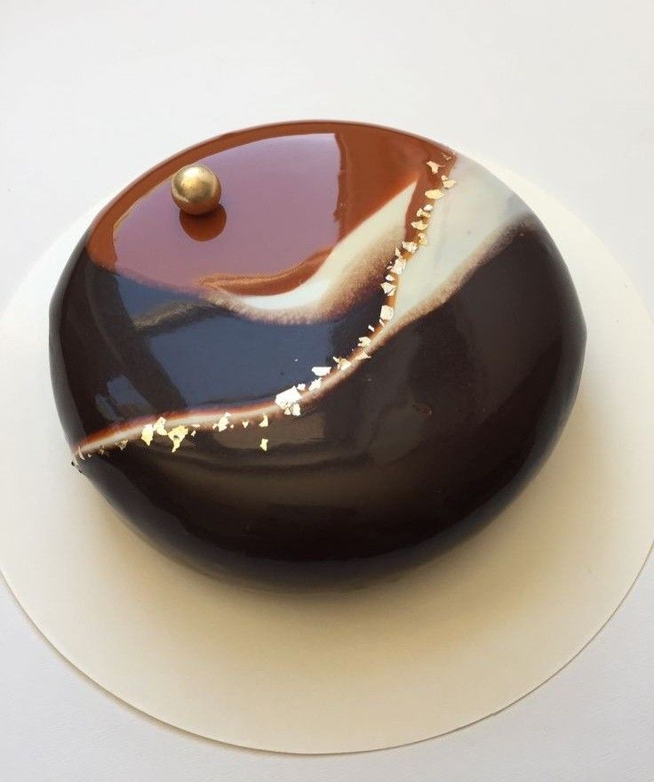 a chocolate cake with white and brown icing