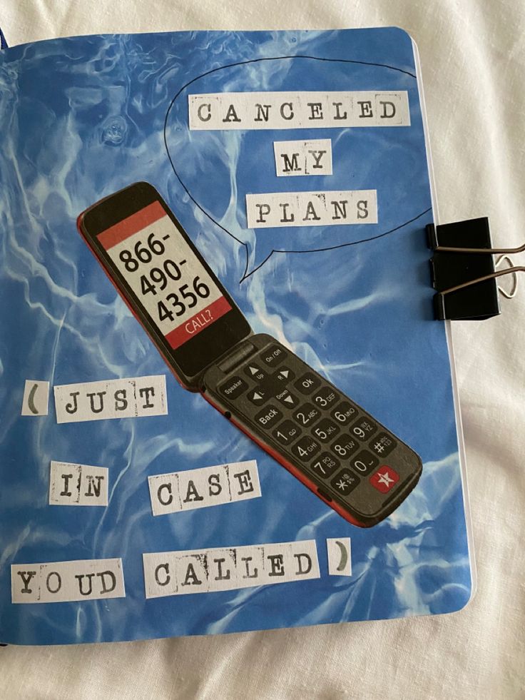 a cell phone sitting on top of a blue notebook with words written in different languages