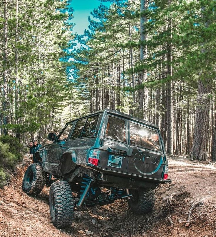 an off road vehicle driving through the woods