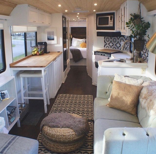 the interior of a camper with couch, kitchen and living room area in it