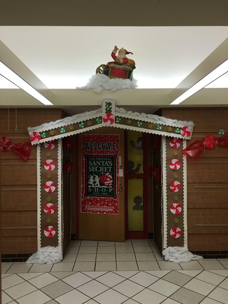 an entrance to a school decorated for christmas with candy canes and decorations on the door