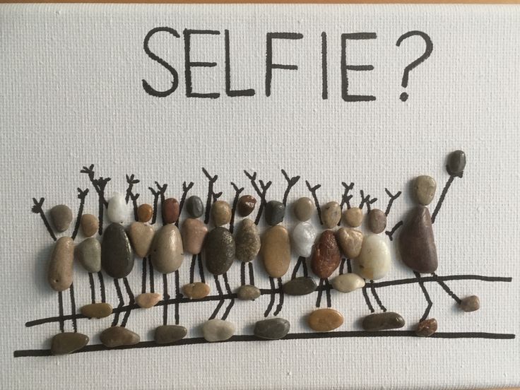 a group of rocks sitting on top of a white board with the words selfie written above them