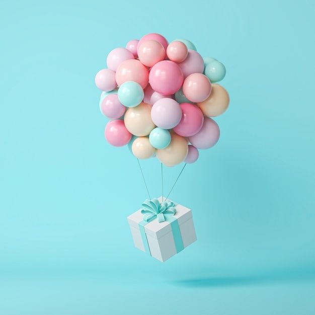 a bunch of balloons floating in the air with a gift box attached to one of them