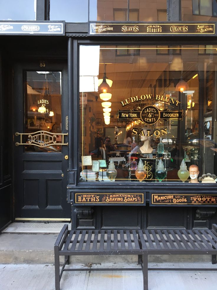 a store front with glass windows and lots of vases