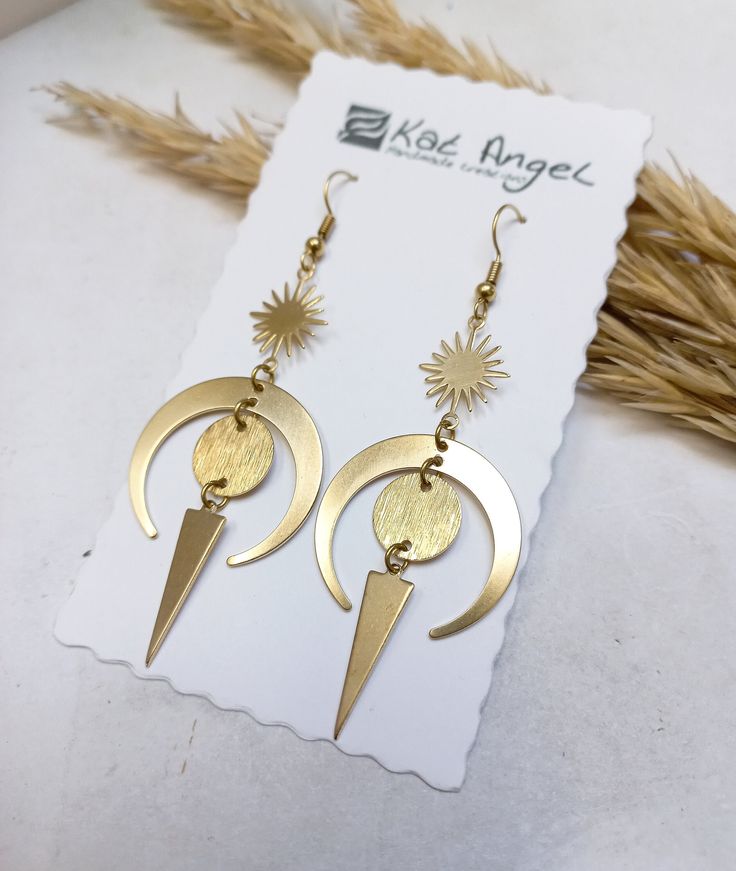 Long Witchy Sun and Moon Earrings 💫 . This pair is made of brass parts. No Nickel, no Lead. . The item will arrive at you wrapped as a gift in a little paper gift bag. . Here are some tips to ensure longevity with my pieces: 》 Avoid showering, swimming, and exercising with my pieces. 》 Avoid wearing perfumes with your jewelry. 》 Avoid sleeping with my pieces on.  》 When not in use, store items in a box. . If you have any questions please contact me, I usually respond quite fast 💌 . Thank you f Unique Moon Phase Earrings For Gift, Celestial Brass Earrings With Ear Wire, Moon Shaped Brass Earrings With Ear Wire, Gold Symbolic Moon Charm Earrings, Gold Symbolic Earrings With Moon Charm, Symbolic Gold Earrings With Moon Charm, Unique Gold Moon Phase Earrings, Brass Moon Shaped Festival Earrings, Handmade Celestial Brass Earrings