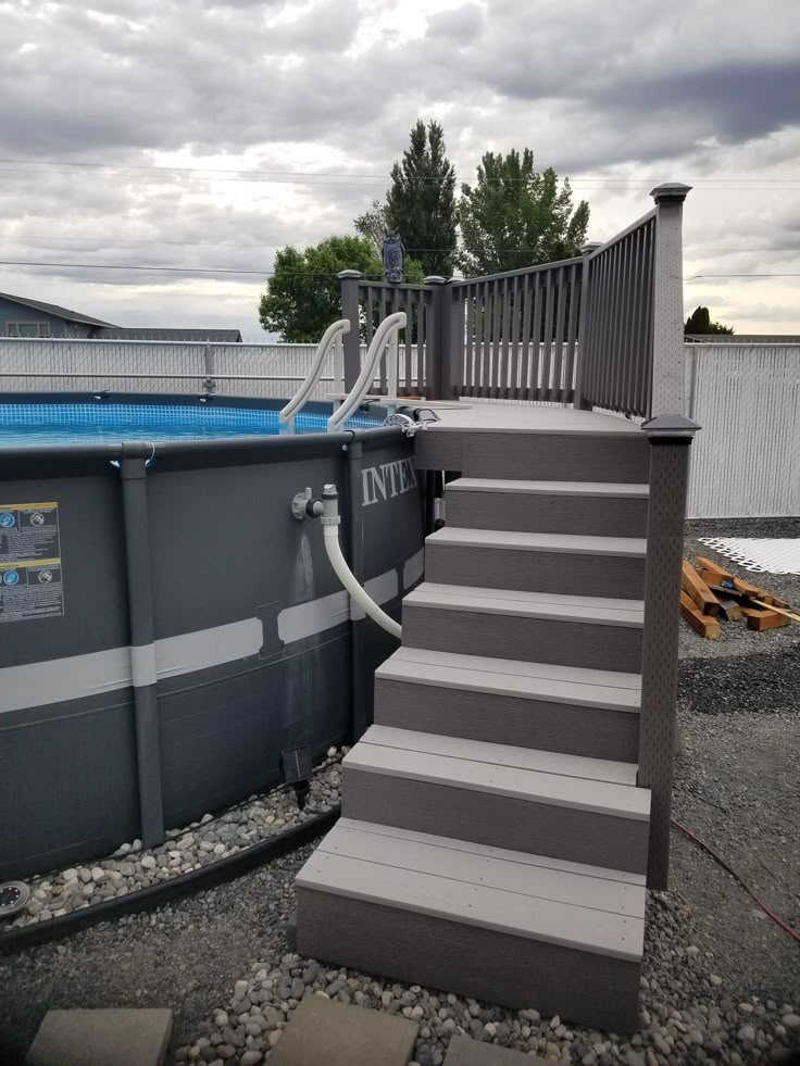 an above ground swimming pool with steps leading up to it