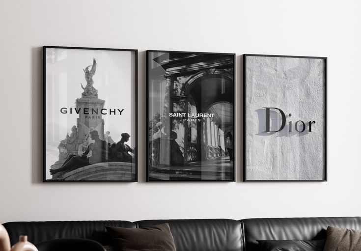 three black and white posters on the wall above a couch