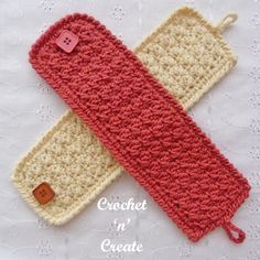 two crocheted pencil cases sitting on top of a white cloth covered tablecloth