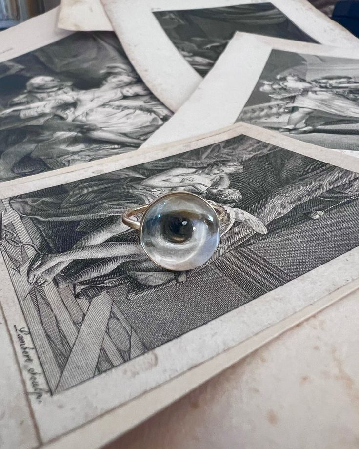 Lover's Eye ring with a round oil painting encased in gold plate over sterling with a quartz crystal cabochon which gives a magical magnifying effect, measuring 1/2"; ring size 6.5. THE HISTORY: Lover's Eyes were a jewelry trend c.1785-1830 of brooches set with tiny watercolor portraits on ivory. Since they were cropped to eyes, they were in many ways more direct and intimate than traditional miniature portraits; but also because they were just eyes, they were often used as daring public testimo Tiny Watercolor, Jewelry Frames, Lovers Eyes, Eye Round, Miniature Portraits, Historical Jewellery, Contemporary Minimalist, Gold Filled Ring, Eye Ring