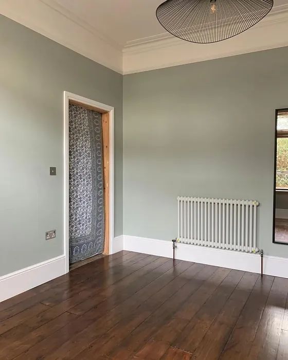 an empty room with hard wood floors and a radiator