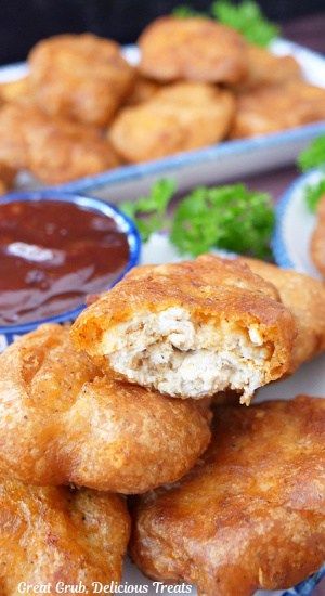 some fried food is on a plate with dipping sauce