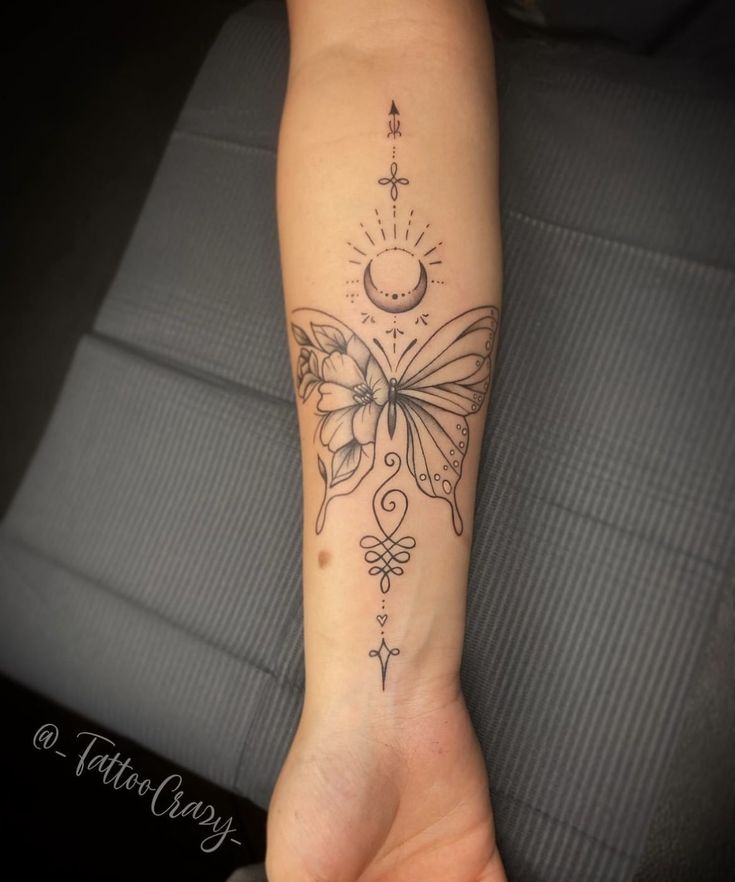 a woman's arm with a butterfly tattoo on it