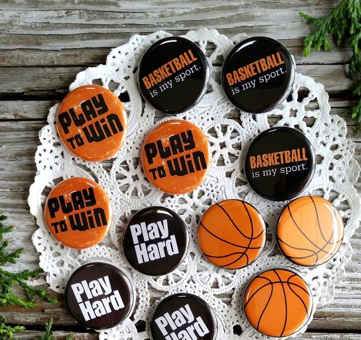 six basketball buttons on a lace doily with the words play hard, play ball