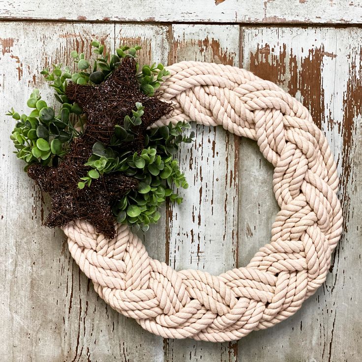 a rope wreath with some plants on it