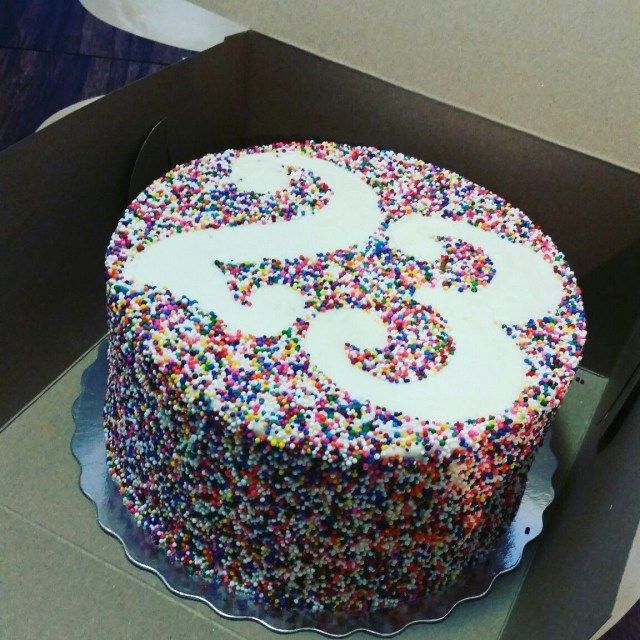 a birthday cake with sprinkles in a box